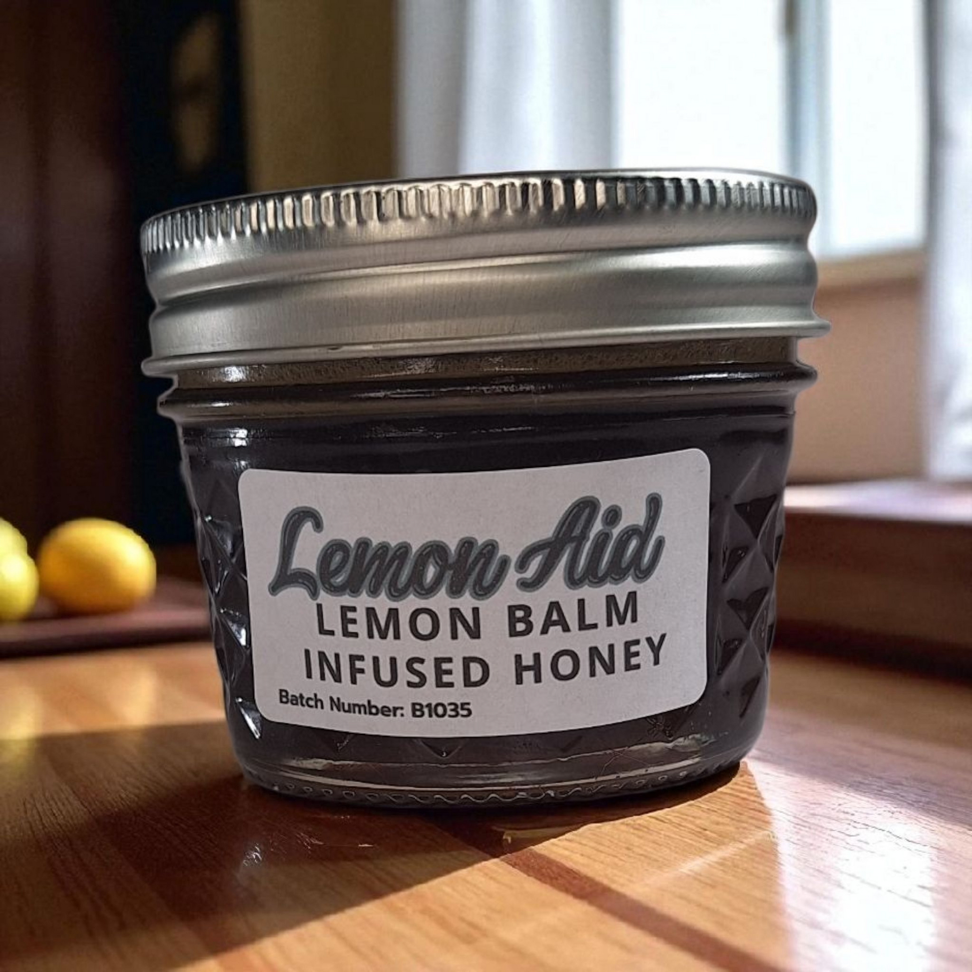 4 oz jar of raw Lemon Balm Infused Honey on a wooden surface, citrusy herbal sweetener for tea, baking, and calming recipes.
